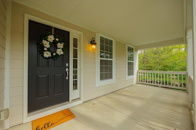 entrance to property featuring a porch