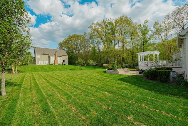 view of yard featuring a wooden deck and a gazebo