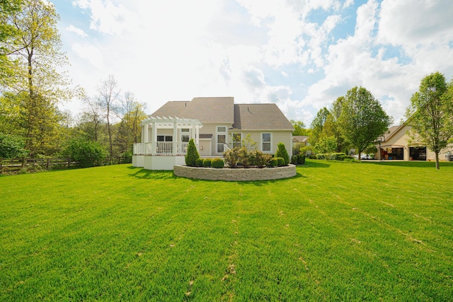 rear view of house featuring a yard and a pergola