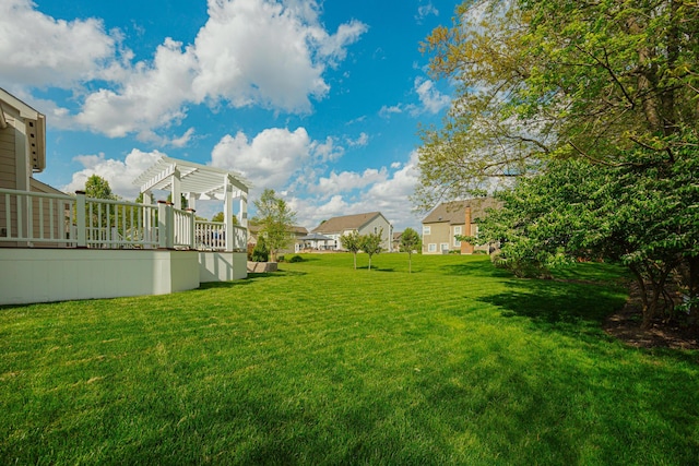 view of yard featuring a wooden deck and a pergola