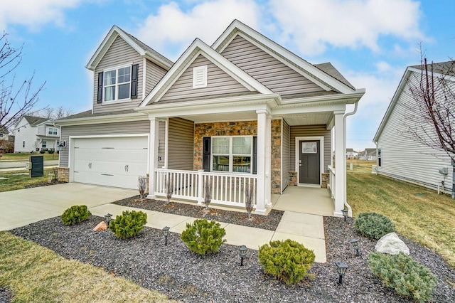 craftsman-style house featuring a garage, a front yard, and covered porch