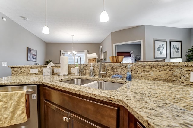 kitchen featuring stainless steel dishwasher, a chandelier, sink, and hanging light fixtures