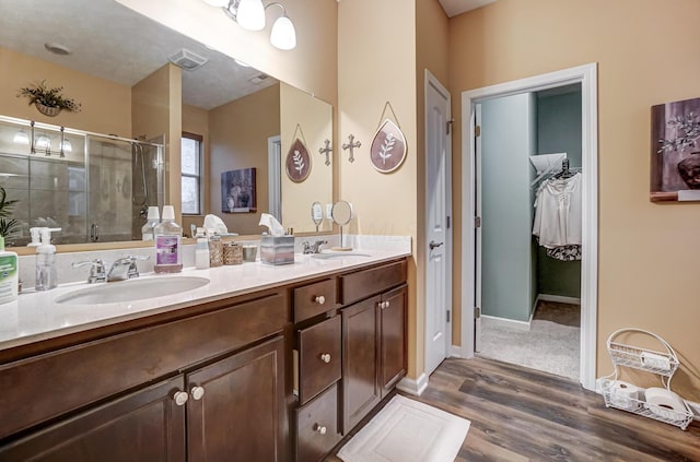 bathroom featuring vanity, hardwood / wood-style floors, and walk in shower