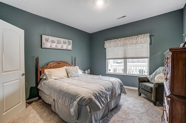 bedroom with light colored carpet