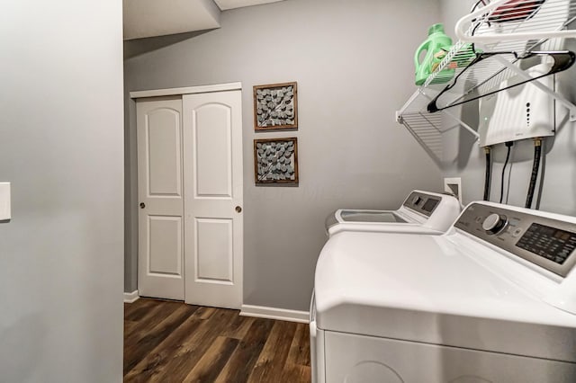 clothes washing area with dark hardwood / wood-style flooring and washing machine and clothes dryer