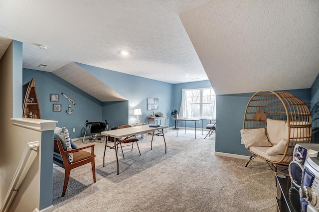 carpeted office with lofted ceiling and a textured ceiling