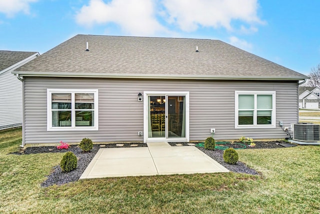 back of property with central AC unit, a patio area, and a lawn