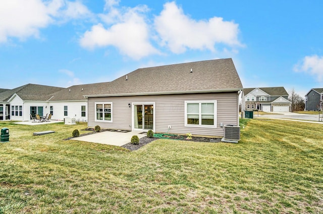 back of house with cooling unit, a yard, and a patio