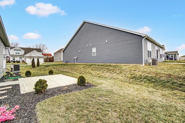 view of yard with central AC unit and a patio area