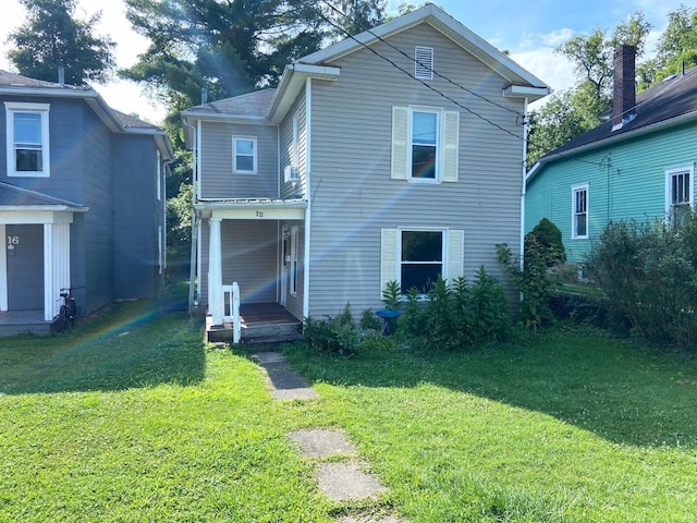 rear view of house with a yard