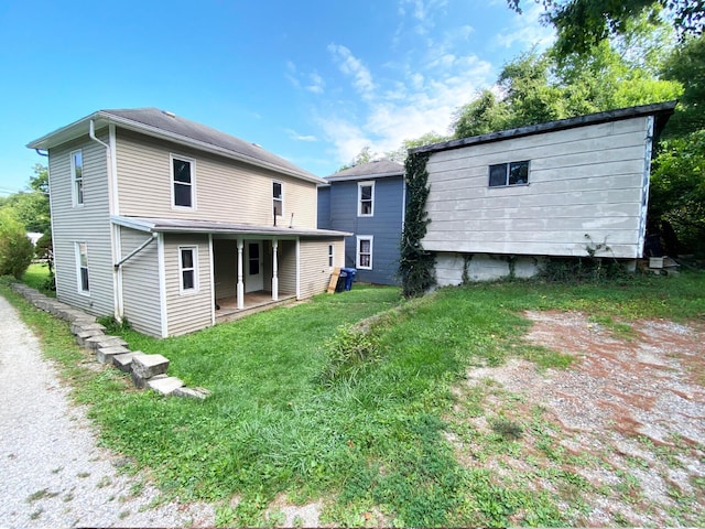 rear view of property with a yard