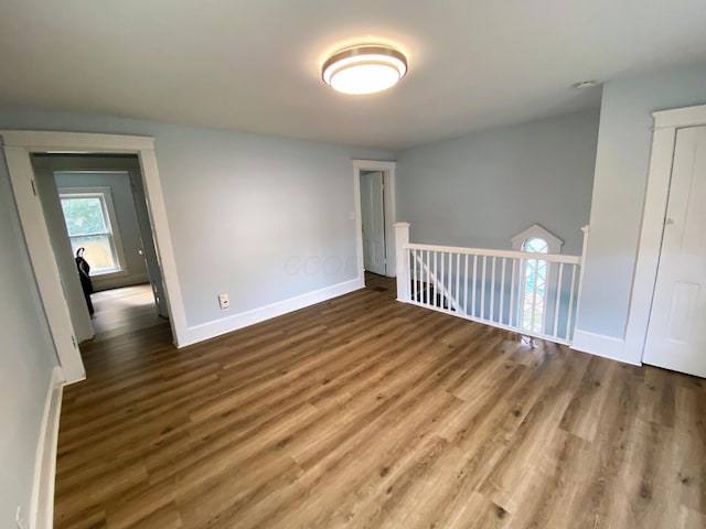 empty room with hardwood / wood-style floors