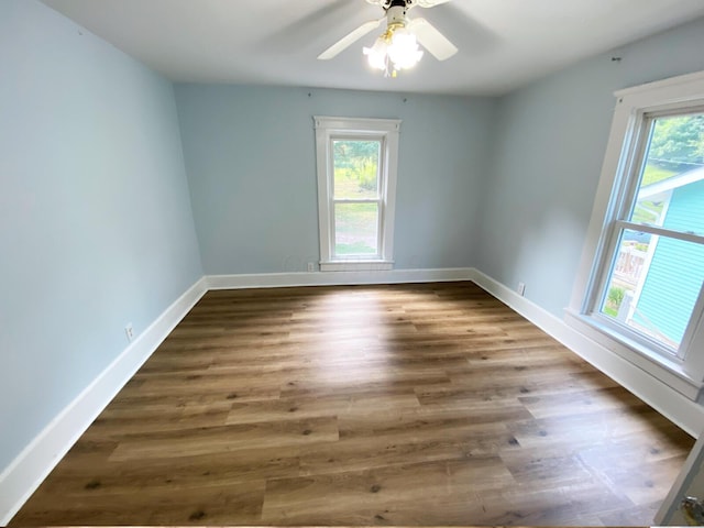 unfurnished room with ceiling fan, plenty of natural light, and dark hardwood / wood-style floors