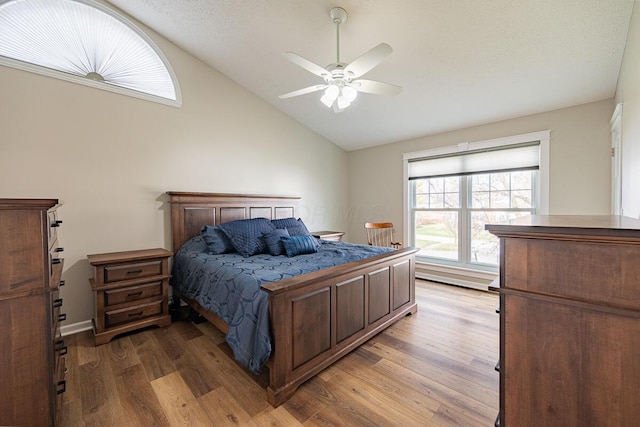 bedroom featuring ceiling fan, lofted ceiling, and light wood-type flooring