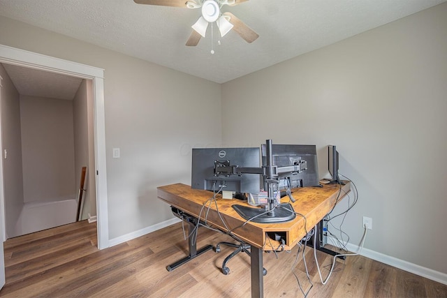 home office featuring hardwood / wood-style floors, a textured ceiling, and ceiling fan