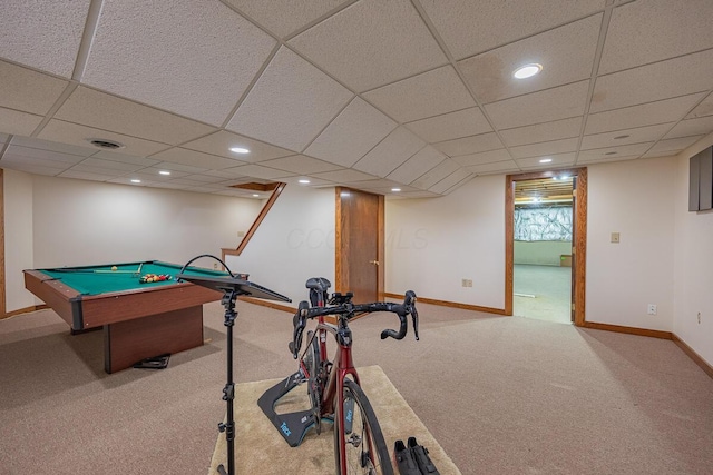 recreation room with a paneled ceiling and light colored carpet