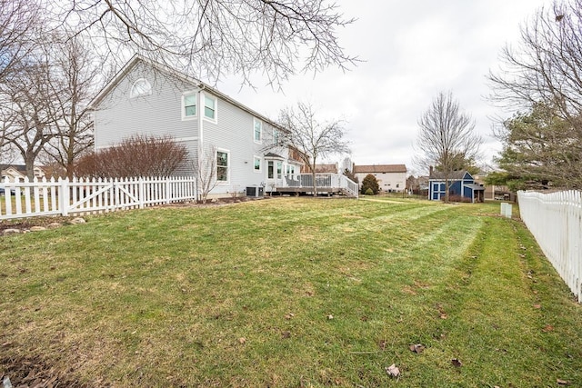 view of yard with cooling unit, an outdoor structure, and a deck