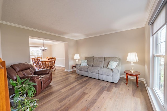 living room featuring hardwood / wood-style flooring, ornamental molding, and a healthy amount of sunlight