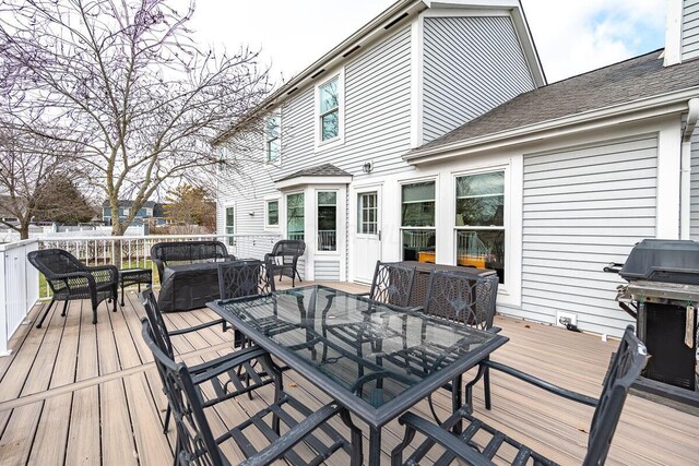 wooden deck featuring a grill