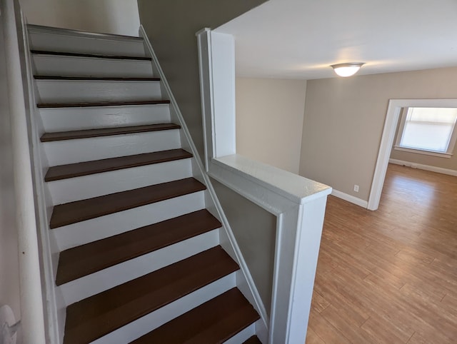 staircase featuring wood-type flooring