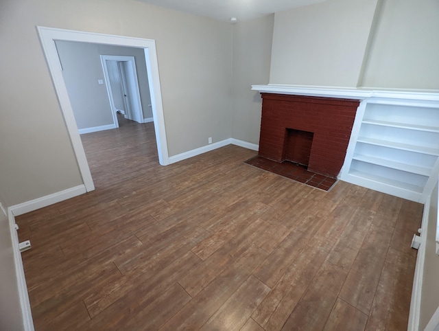 unfurnished living room with hardwood / wood-style flooring and a fireplace