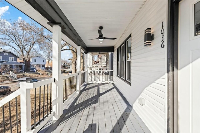 wooden deck featuring ceiling fan and a porch