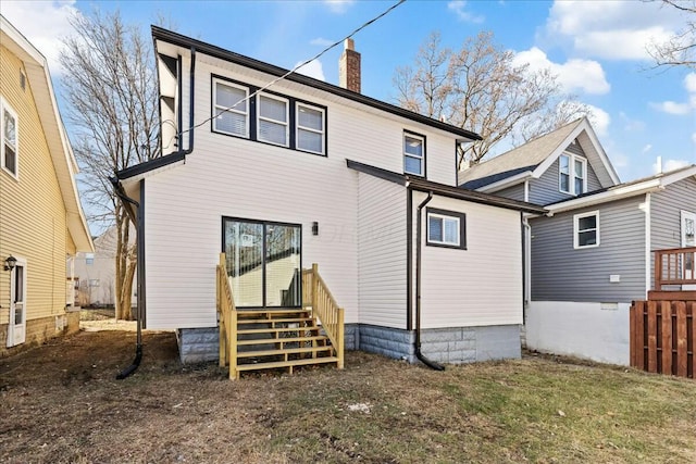 rear view of house featuring a yard