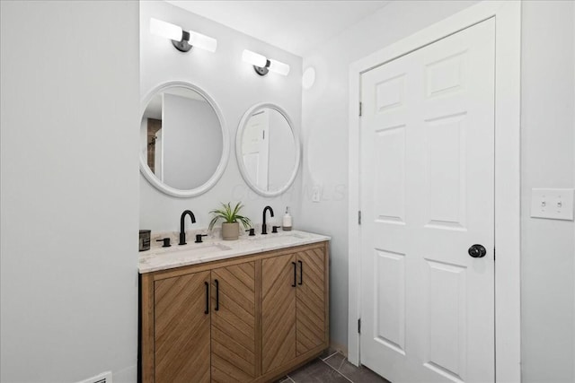 bathroom with tile patterned floors and vanity