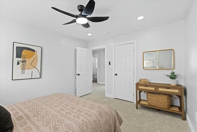 bedroom featuring light colored carpet and ceiling fan