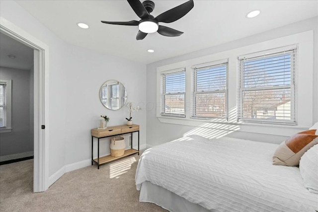 bedroom featuring light colored carpet and ceiling fan