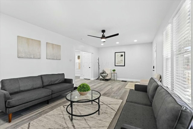 living room featuring hardwood / wood-style floors and ceiling fan