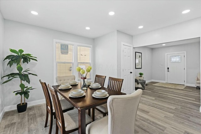 dining space with a healthy amount of sunlight and light hardwood / wood-style flooring