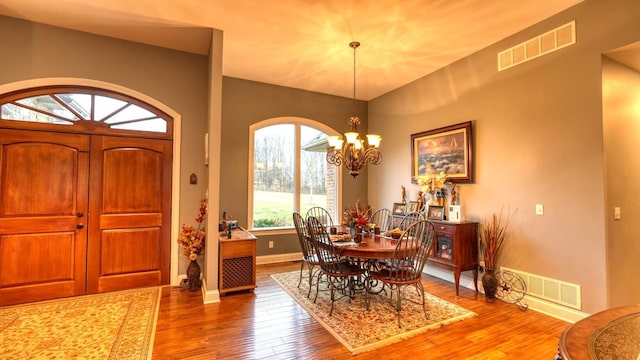 dining room featuring an inviting chandelier and hardwood / wood-style floors