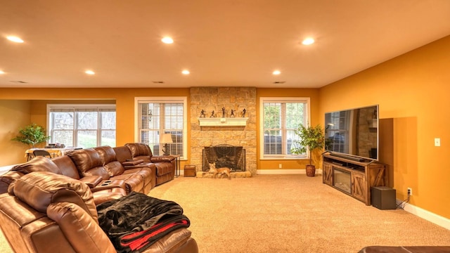 living room featuring a stone fireplace and carpet floors