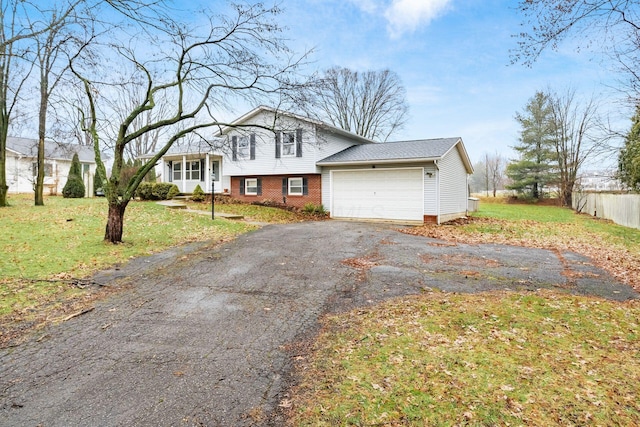 tri-level home with a garage and a front yard