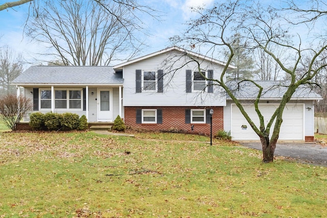 split level home featuring a garage and a front lawn