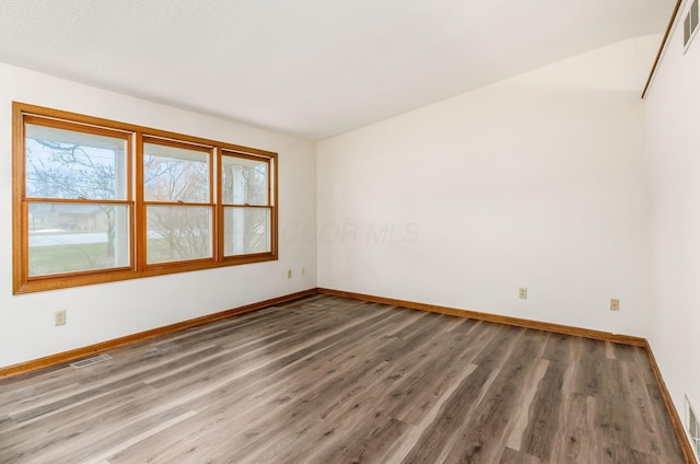 unfurnished room featuring hardwood / wood-style flooring