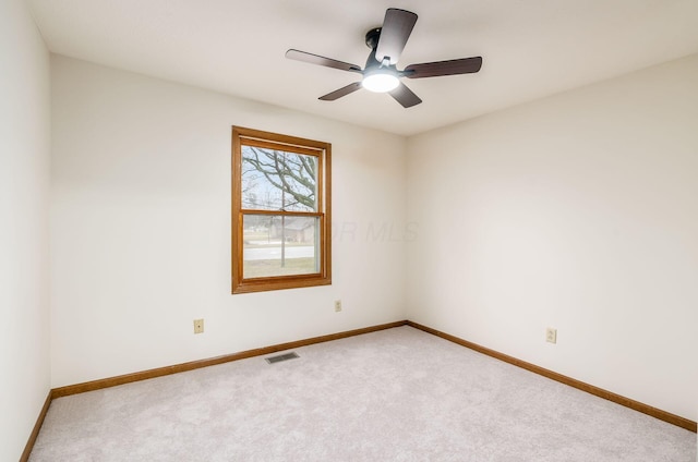 empty room with ceiling fan and carpet