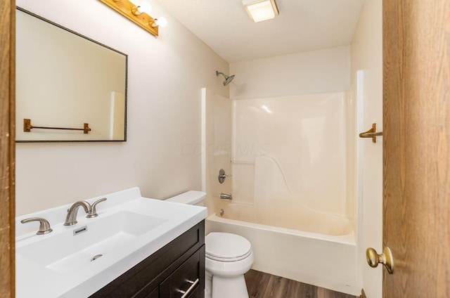 full bathroom with shower / bathing tub combination, vanity, wood-type flooring, and toilet