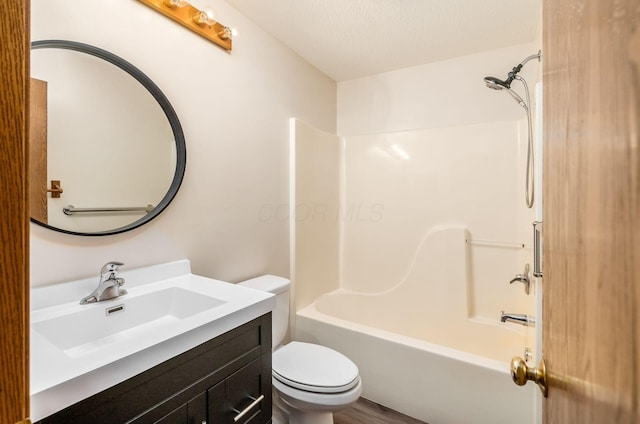 full bathroom with bathtub / shower combination, vanity, toilet, and a textured ceiling