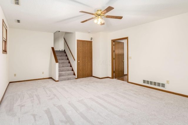 spare room with light carpet and ceiling fan