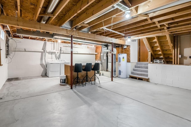 basement featuring washer and dryer and electric water heater