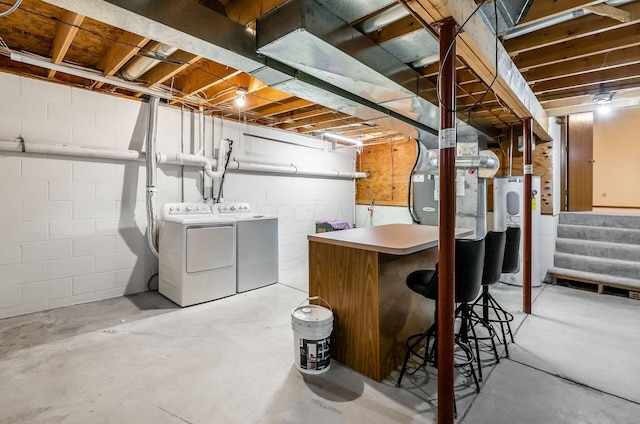 basement featuring washer and clothes dryer and water heater