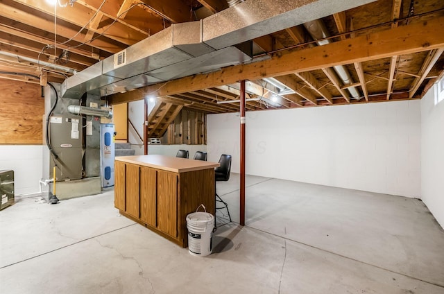 basement with heating unit and electric water heater