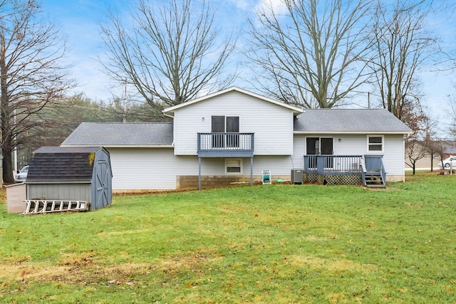 rear view of property with a wooden deck, a yard, central AC, and a storage shed