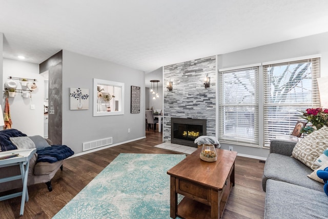 living room with dark hardwood / wood-style flooring and a tile fireplace