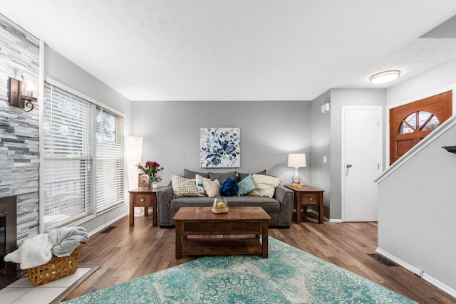 living room featuring hardwood / wood-style flooring and a fireplace