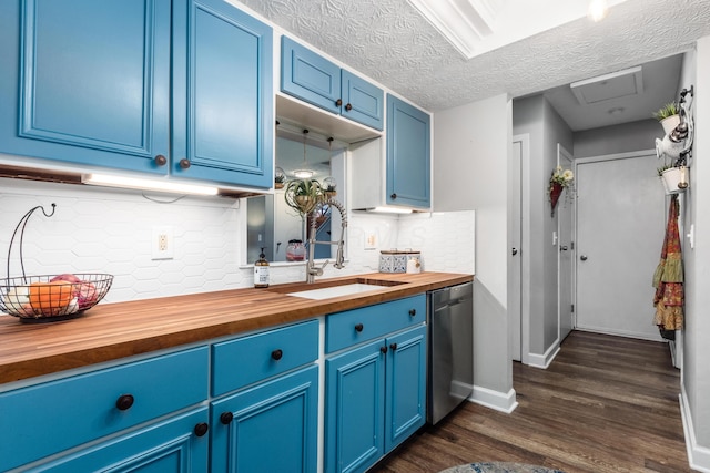 kitchen featuring dishwasher, butcher block counters, sink, and blue cabinetry