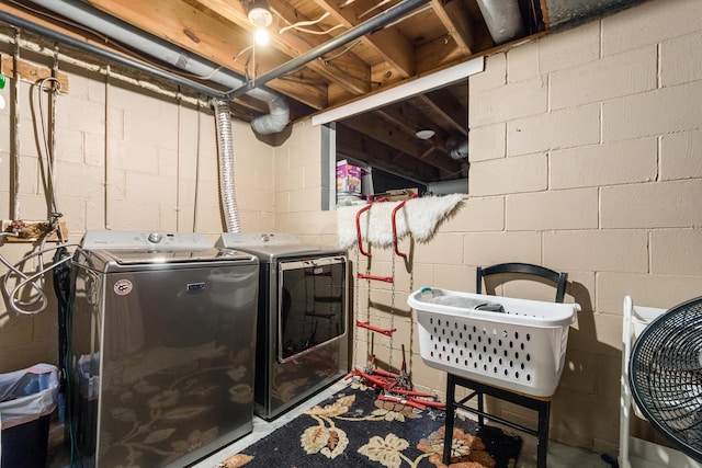 clothes washing area with washing machine and dryer