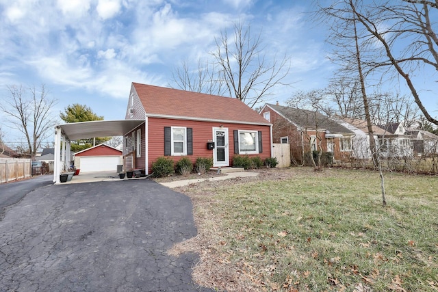 view of front of house with a garage, an outdoor structure, and a front lawn